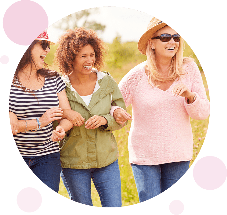 Women smiling and walking together.