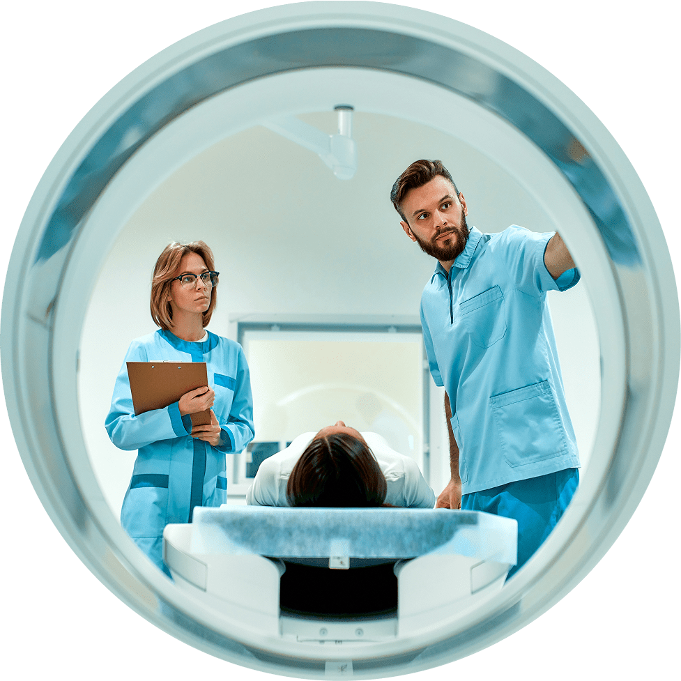 Doctors with patient on radiology machine in office.