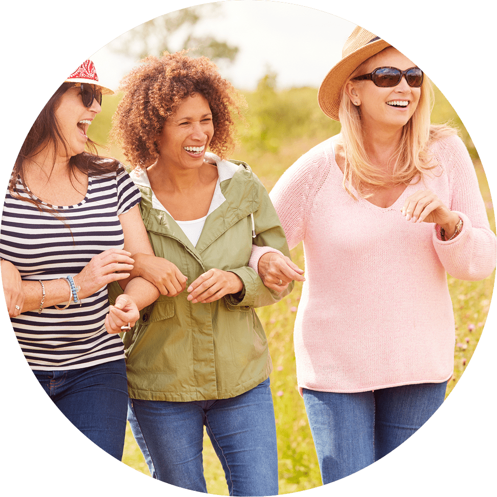 Women smiling and walking together.