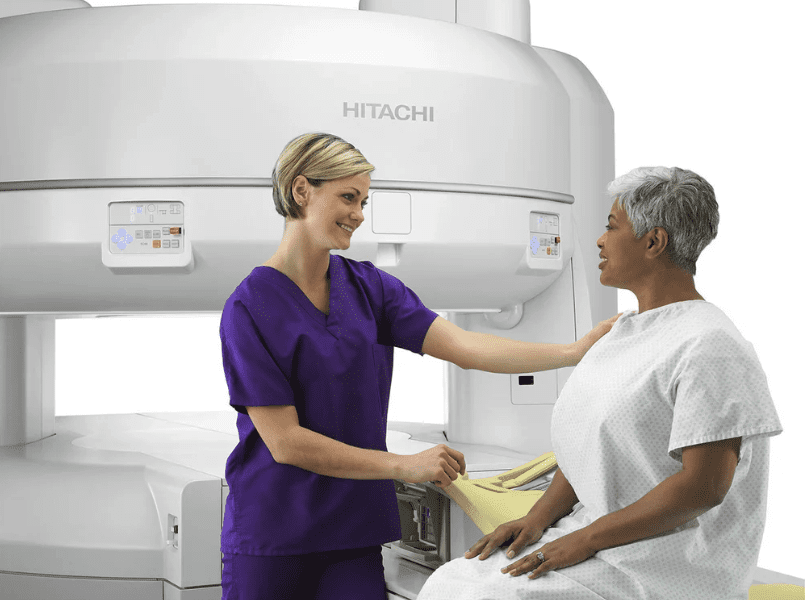 Doctor helping patient take scan.