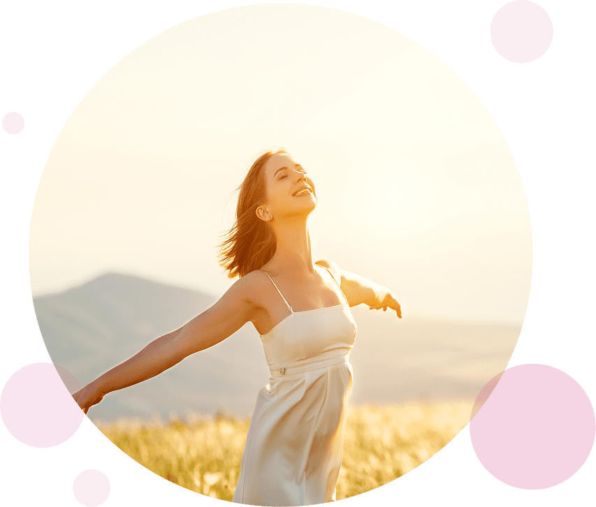 Women running free in wheat fields with sun shining in the background.