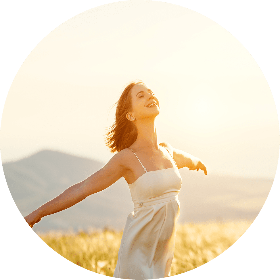 Women running free in wheat fields with sun shining in the background.