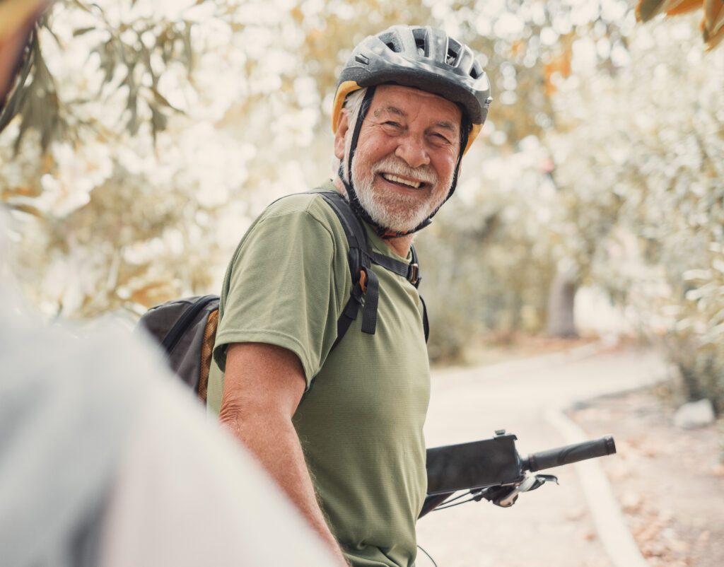 Older man enjoying riding a bike.