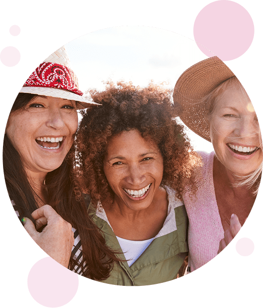 Older women smiling and laughing with sunshine in the background.