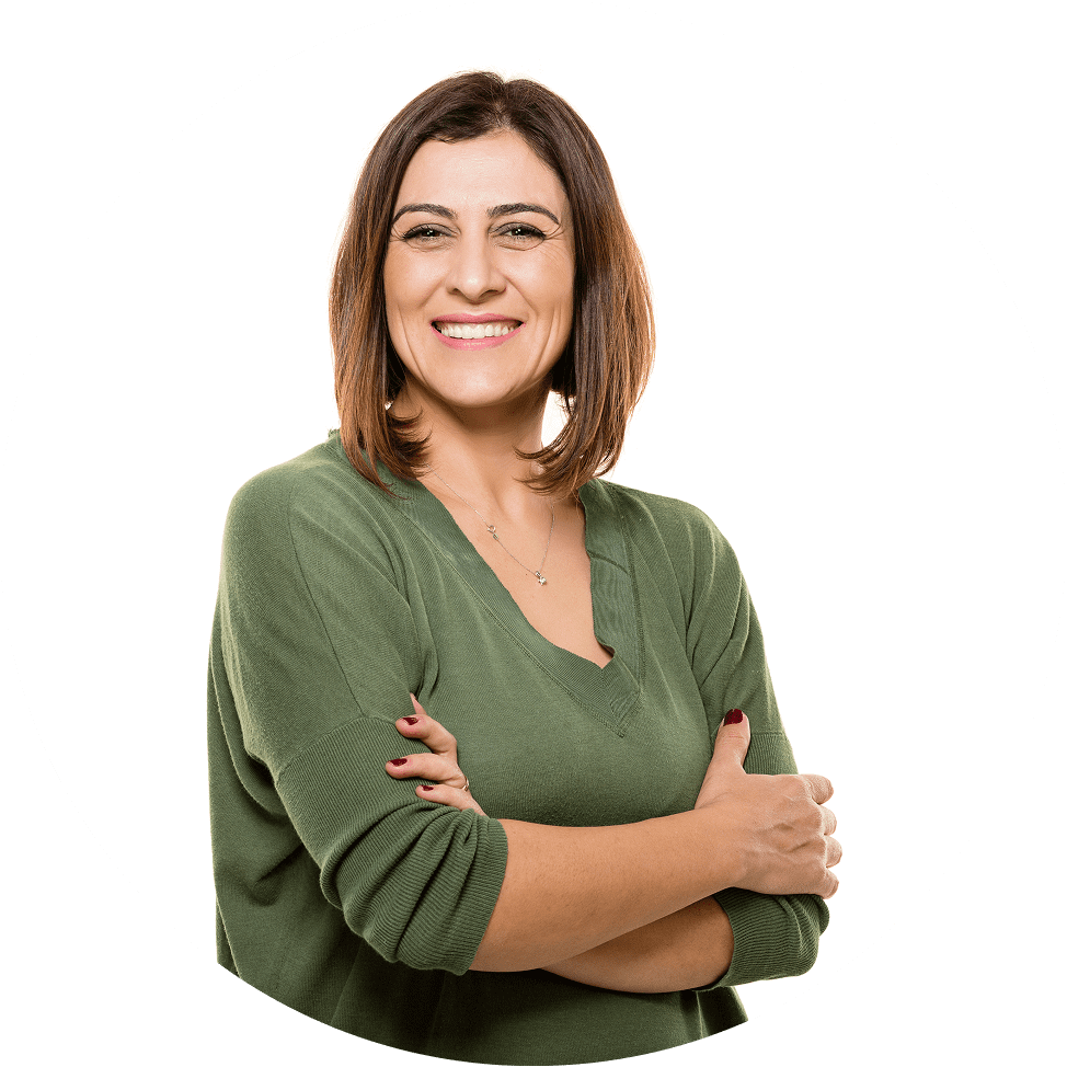 Women in her 40's smiling for photo and holding her arms.