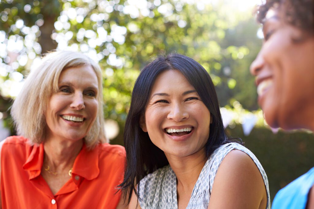 Women smiling and talking with her friends.