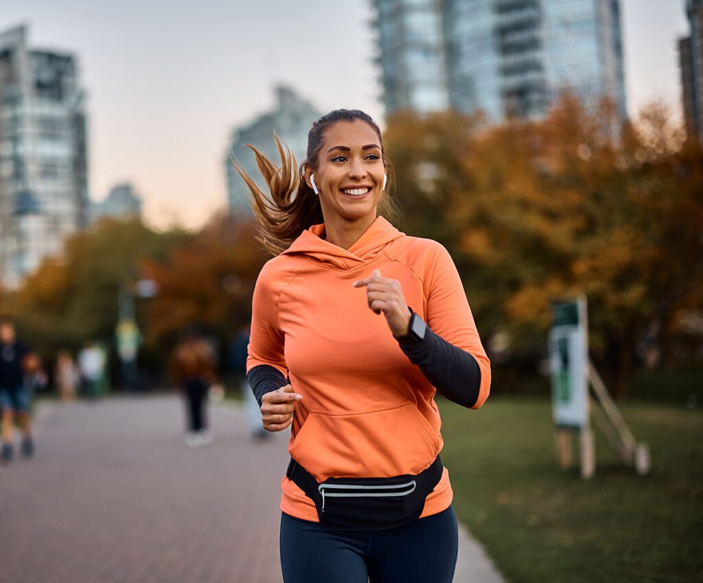 Happy women running while listening to music.