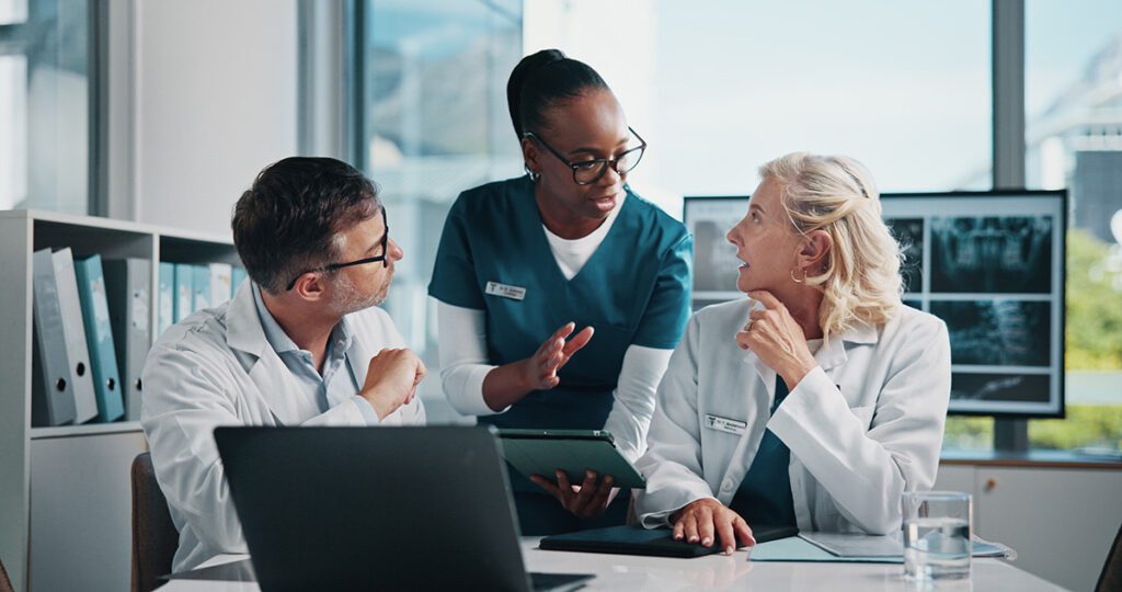 doctors and nurses at a table having a meeting and talking