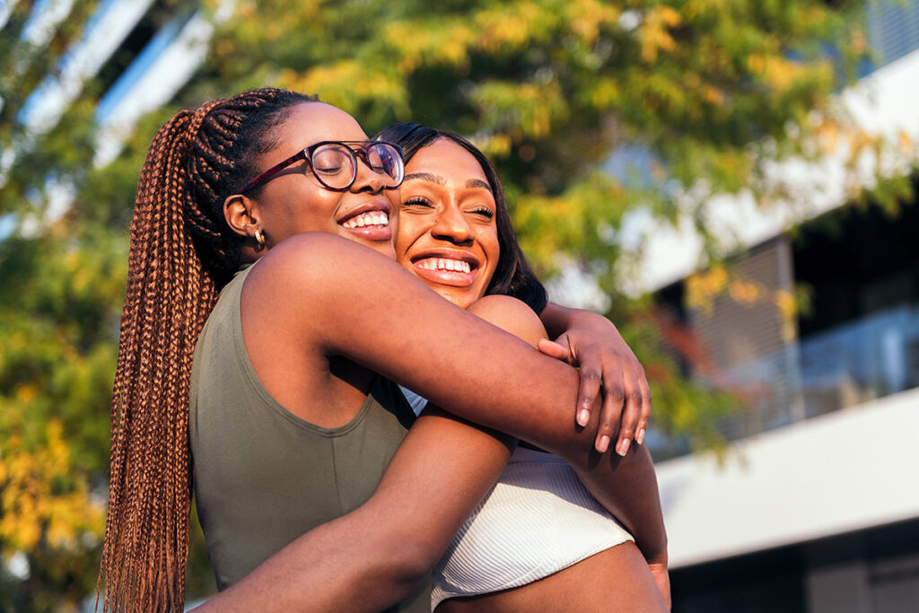 two happy women hugging and smiling