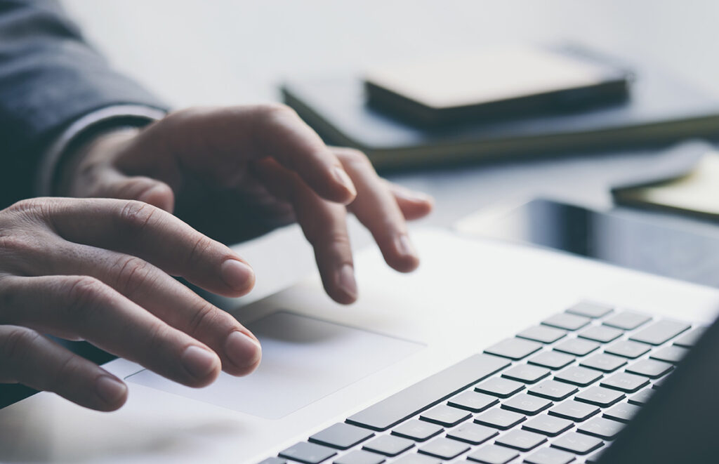 using laptop and analysing the financial information